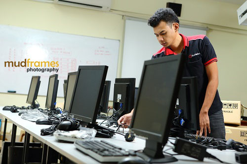 Rentwise engineer setting up computers at SMK St. Mary School's computer lab