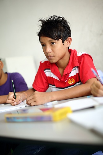 A Myanmar child refugee studying at PBCC Learning Centre in Selayang
