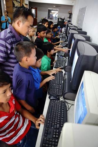 Myanmar children refugees using donated computers by Rentwise at PBCC Learning Centre in Selayang