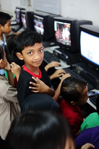 Myanmar children refugees using donated computers by Rentwise at PBCC Learning Centre in Selayang