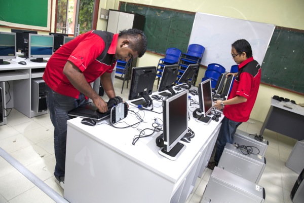 Rentwise engineers setting up refurbished desktop computers at Sekolah Kebangsaan (P) Methodist Klang as part of Rentwise's CSR Program