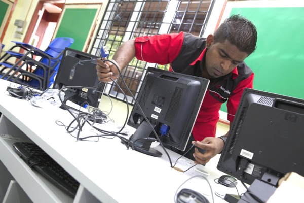 Rentwise engineers setting up refurbished desktop computers at Sekolah Kebangsaan (P) Methodist Klang as part of Rentwise's CSR Program