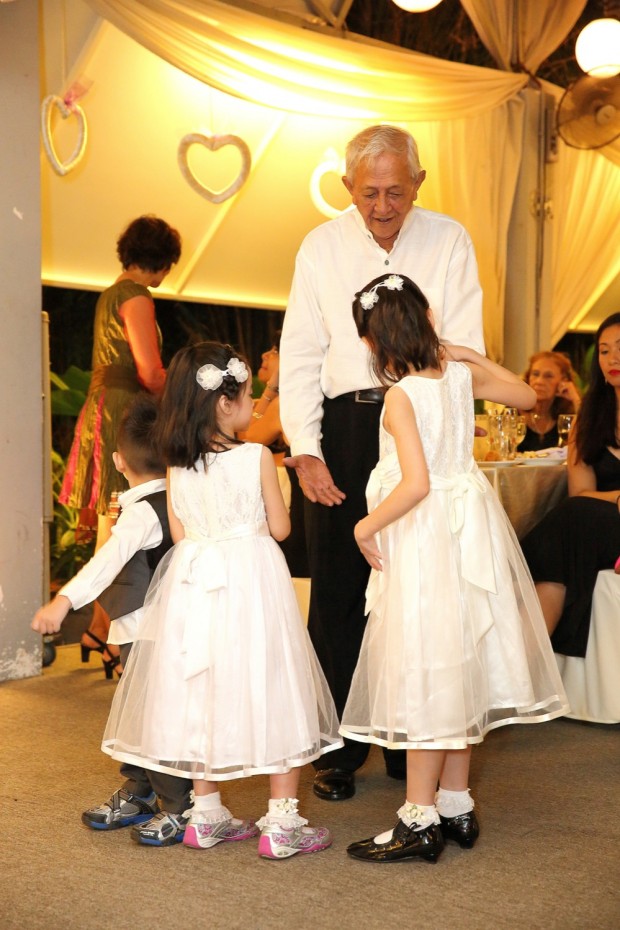 Grandpa and lovely grandchildren during wedding dinner reception at Passion Road