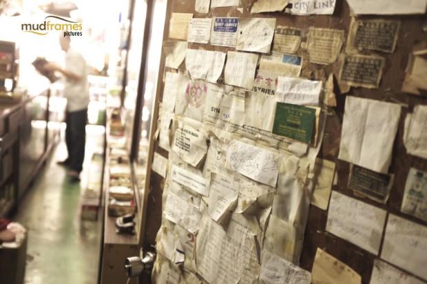 Scribblings on papers and cut-outs found on the wall of Kok Ann medical store at Kuching, Malaysia