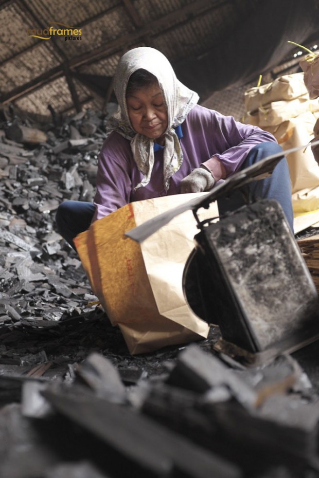 A worker at the charcoal factory at Kuala Sepetang